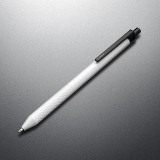 James The Burwell Ballpoint Pen in Bone and Black finish, angled on grey