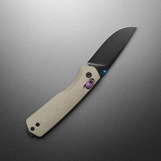 James The Carter Knife with beige Micarta handle and black VG-10 blade angled on gray background