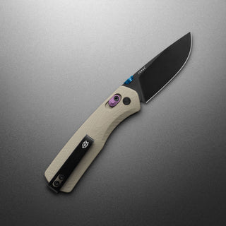 James The Carter Knife with beige Micarta handle and black VG-10 steel blade partially open on gray background
