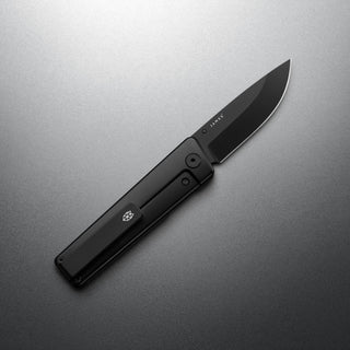 James The Chapter 2 Knife with sleek black titanium handle and sharp blade on gray background