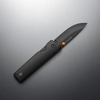 James The Chapter 2 Knife with sleek black handle and sharp titanium blade open on gray background