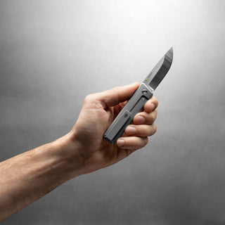 Hand holding James The Chapter 2 Knife by The James Brand showing titanium handle and s35vn blade
