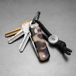 James The Elko Knife with eco-acetate handle attached to keyring and black cord by The James Brand