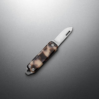 James The Elko Knife with tortoiseshell eco-acetate handle and stainless steel blade on gray background