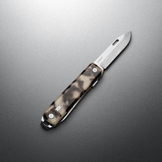 James The Ellis Scissors Knife with eco-acetate handle and polished stainless steel blade on gray surface