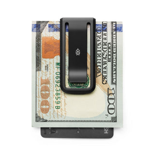 James The Martindale Money Clip holding cash and card with sleek black titanium finish and small logo detail