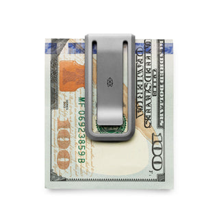 James The Martindale Money Clip holding folded hundred dollar bills in sleek titanium finish