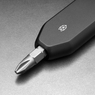 James The Warrick Bit Driver with sleek black anodized aluminum handle and precision screwdriver bit close-up