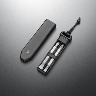 James The Warrick Bit Driver with anodized aluminum case and four screwdriver bits displayed on black surface
