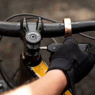 James The Warrick Bit Driver in use tightening a black bike handlebar bolt with anodized aluminum body