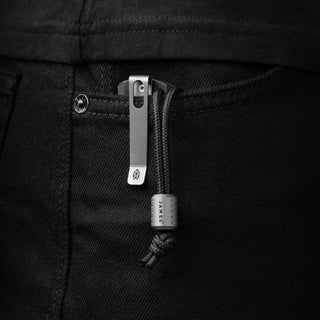 James The Alder Lanyard & Bead clipped on black denim pocket with titanium bead and nylon paracord loop
