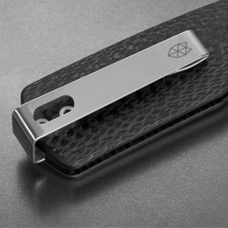 James The Carter Knife close-up on carbon fiber handle and stainless steel pocket clip showing logo engraving