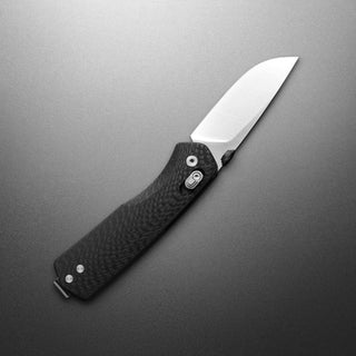James The Carter Knife with black G10 handle and polished VG-10 steel blade displayed open on gray background
