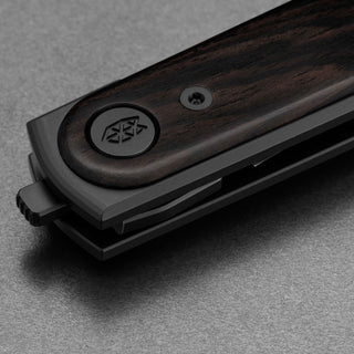 James The Duval Knife close-up showing rosewood handle and black metal frame lock detail