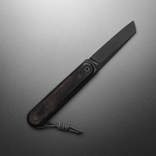 James The Duval Knife with black blade and dark rosewood handle shown open on dark background