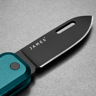 James The Elko Knife with black Sandvik steel blade and teal textured handle close-up view