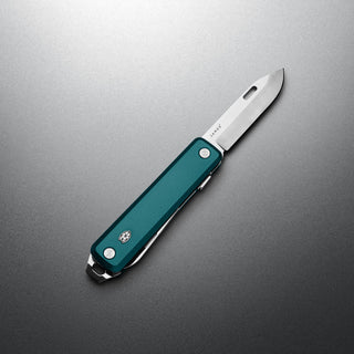 James The Ellis Scissors Knife with teal Micarta handle and stainless steel blade partially open on gray surface