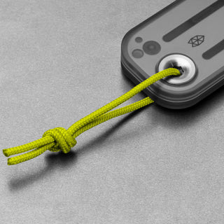 James The Palmer Recycled PC Knife showing translucent handle and green lanyard detail on gray surface