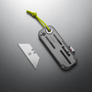 James The Palmer Recycled PC Knife with lime green lanyard and detached high carbon steel blade on gray background
