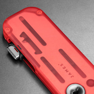 James The Palmer Recycled PC Knife in translucent red recycled PCTG with visible internal components and edge tool