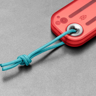 James The Palmer Recycled PC Knife red handle close-up with blue lanyard detail on gray background