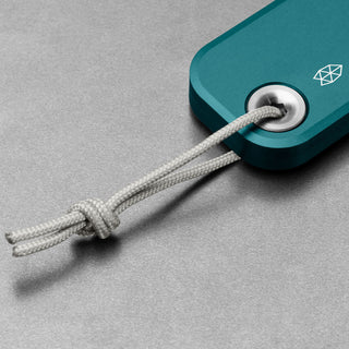 James The Palmer Knife anodized teal handle close-up showing braided cord loop detail