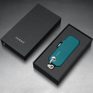 James The Palmer Knife in teal anodized aluminum shown inside black branded packaging by The James Brand