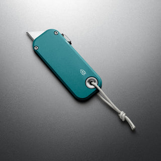 James The Palmer Knife with anodized teal aluminum handle and high carbon steel blade partially extended