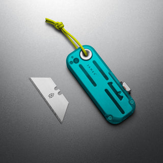 James The Palmer Recycled PC Knife with turquoise recycled plastic handle and exposed utility blade next to it