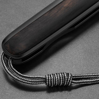 James The Pike Knife showing ebony handle with black and white braided lanyard looped through end hole