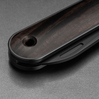 James The Wayland Knife handle close-up showing smooth dark ebony scales and matt black frame design