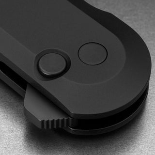 Close-up of James The Wells Knife showing matte black aerospace grade aluminum handle and button lock mechanism