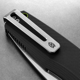 Close-up of James The Folsom Pro Knife showing black G10 handle with textured grip and stainless steel clip