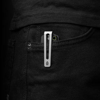 James The Folsom Pro Knife with stainless steel clip partially visible in black denim pocket