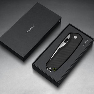 James The Folsom Pro Knife in black G10 handle resting in sleek black James Brand packaging box