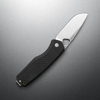 James The Folsom Pro Knife with black G10 handle and sharp stonewash LC200N steel blade angled on gray background