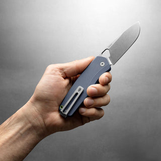 Hand holding James The Folsom Pro Knife with textured blue G10 handle and stonewash blade