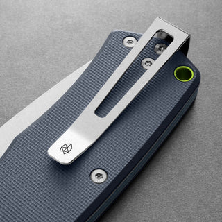 James The Folsom Knife showing textured blue G10 handle with silver clip and bright green lanyard hole