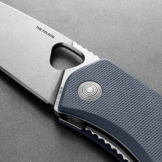 James The Folsom Knife close-up showing VG-10 blade and textured blue G10 handle with liner lock mechanism