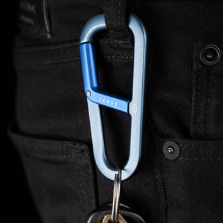 James The Hardin Carabiner in anodized blue aluminum clipped on black fabric loop with keys attached