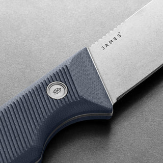 James The Humboldt Knife with textured blue G10 handle and Böhler N690 stainless steel blade close-up