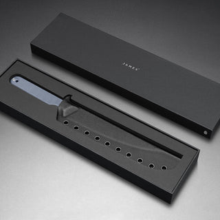 James The Humboldt Knife with textured blue G10 handle displayed in black protective kydex sheath and branded box