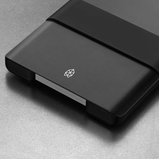 James The Lowe Wallet in matte black aluminum with silicone band and compact card storage design