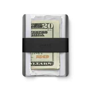James The Lowe Wallet with silver aluminum body and black silicone band holding cash and cards securely