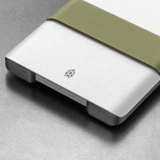 James The Lowe Wallet by The James Brand in silver aluminum with olive green silicone band close-up