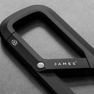 James The Madison Carabiner in matte black aluminum with sleek geometric logo and spring gate design