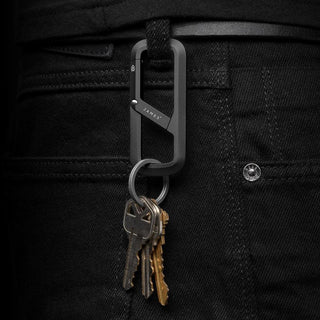 James The Madison Carabiner in matte black aluminum attached to black denim holding keys