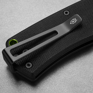 Close-up of James The Folsom Knife black G10 handle with clip featuring The James Brand logo detail