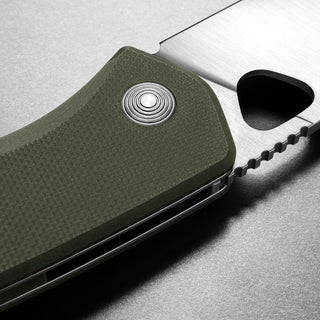 Close-up of James The Folsom Knife showing textured green G10 handle and VG-10 steel blade edge details