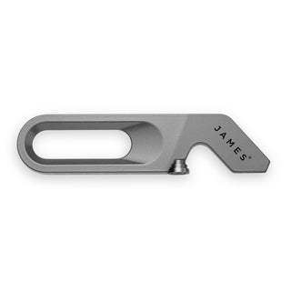 James The Halifax Multitool in titanium with a slim rectangular cutout and angled screwdriver tip